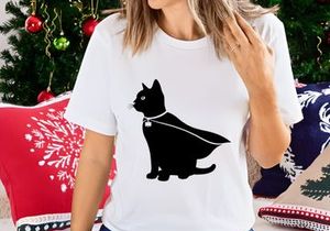 Black cat in cape and shamrock charm