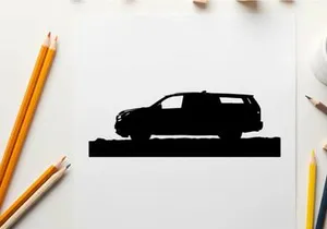 Silhouette of a car in front of mountains