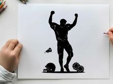Football player silhouette celebrating with arms raised high