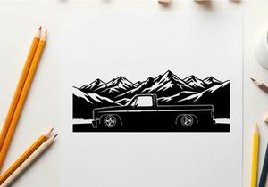 Silhouette of a pickup truck in front of majestic mountain range silhouette