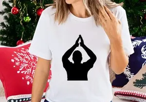 A person in a yoga pose with hands together above their head in silhouette
