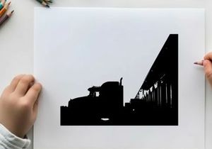 Truck silhouette parked beside a building at sunset