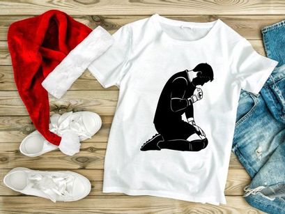 Man kneeling in prayer or contemplation with clasped hands