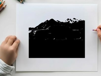 Silhouette of a pickup truck in front of a mountain range