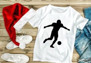 Silhouette of a soccer player kicking a ball in mid action