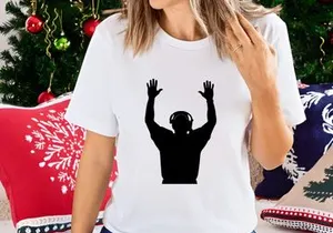 Silhouette of a man wearing headphones with hands raised in the air