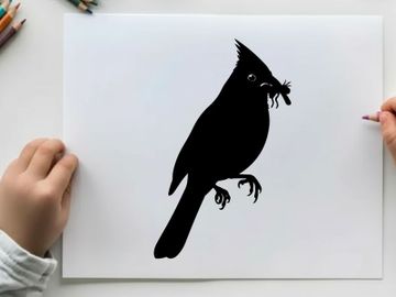 Silhouette of a cardinal holding a worm in its beak profile view preview picture