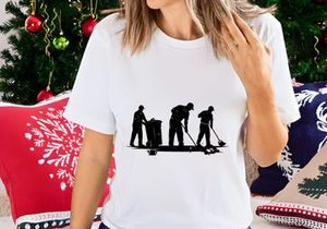 Silhouette of three workers cleaning the street with broom and trash can