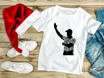 Silhouette of a referee in a black and white striped uniform signaling a call