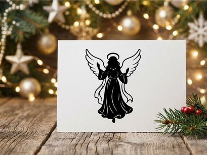Black silhouette of a Christmas angel with wings and halo isolated on white background