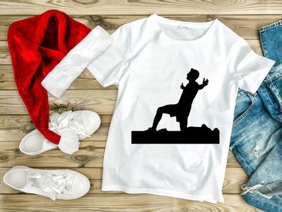 A silhouette of a man in a dynamic yoga pose outdoors