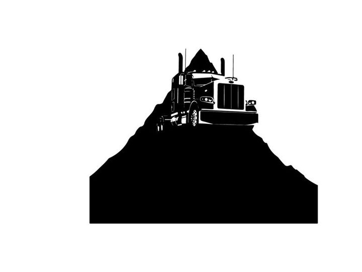 Silhouette of a semi truck on a hill
