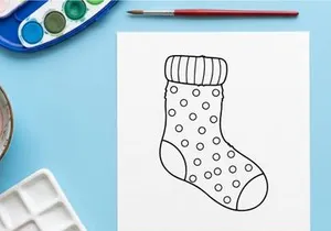 Hand drawn Christmas stocking with polka dot pattern isolated on white background