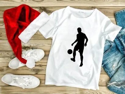 Silhouette of a soccer player kicking a ball in mid action