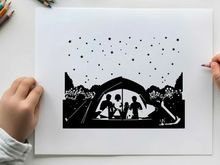 Silhouette of family in tent under starry night sky