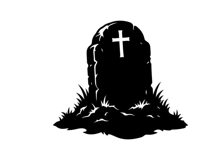 Silhouette of a Cross on a Tombstone in Graveyard Scene