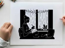 Silhouette of a woman writing by the window at night