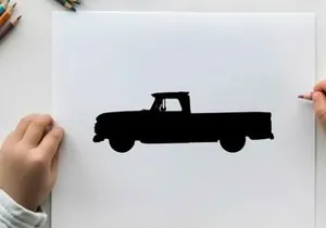 Silhouette of a classic pickup truck against a white background