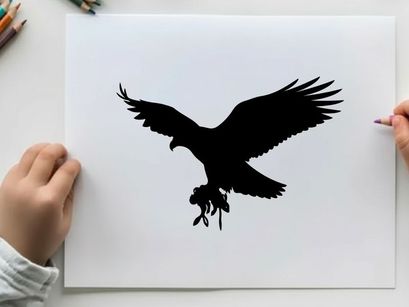 Silhouette of an eagle in flight with outstretched wings and talons extended