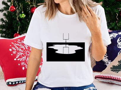 A black and white image of a football goal post reflected in a puddle of water