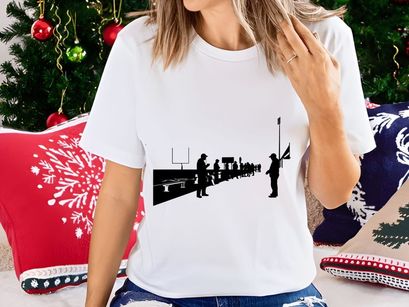 Silhouettes of people standing on a sports field with goalposts and bleachers