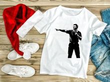 A man in a black shirt pointing to the left with a microphone