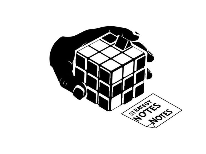 Hand holding a rubik's cube with strategy notes silhouette