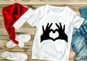 Hands forming heart shape shadow love symbol on white background