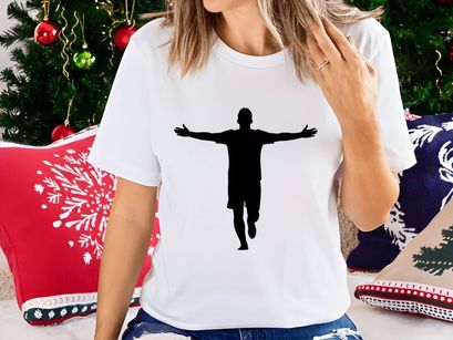 Silhouette of a man with arms outstretched in a triumphant or celebratory pose