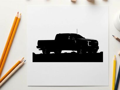 Silhouette of a pickup truck against a mountain range silhouette