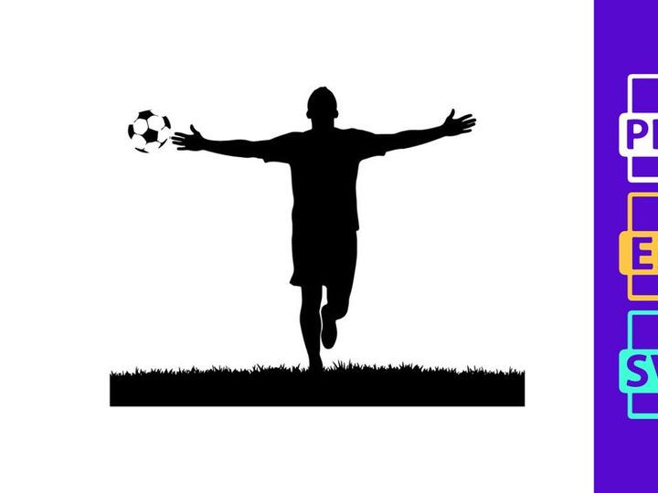Silhouette of a soccer player in mid action kicking a ball