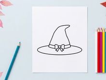 Halloween witch hat with bow isolated on white. Classic black pointed sorcerer hat for costumes and party decor.