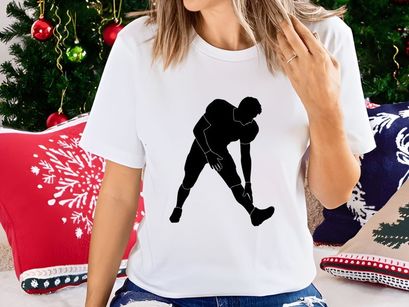 Black silhouette of a person stretching their leg