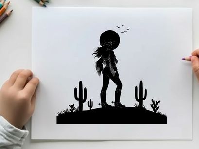 Silhouette of a cowboy standing on a desert hill