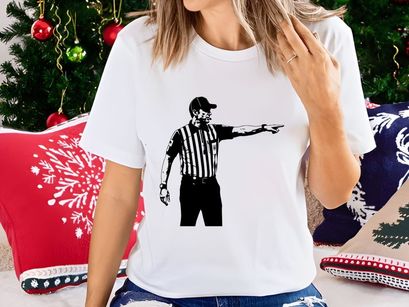 A black and white image of a referee pointing to the right in a striped shirt