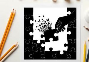 Silhouette of hand placing puzzle piece with butterflies and flowers emerging