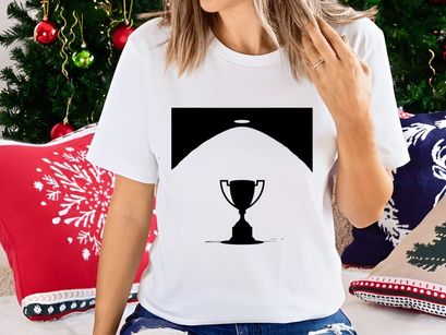 A shining spotlight on a classic trophy cup in a dark room