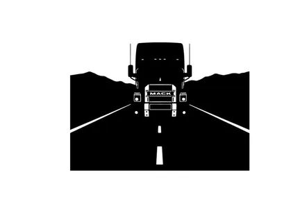Silhouette of a large truck driving down a deserted highway at night
