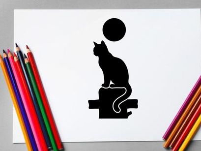 Silhouette of a cat sitting on a ledge with a full moon in the night sky