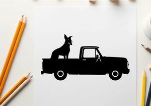 Silhouette of a dog sitting in the back of a pickup truck