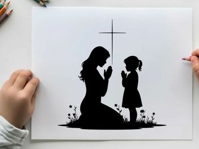 Silhouette of mother and child praying together under cross