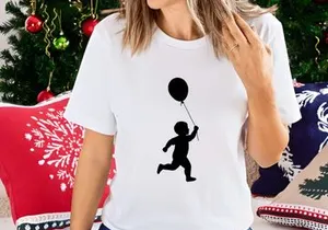 Silhouette of a toddler boy running with a balloon