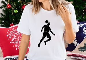 Silhouette of a soccer player kicking a ball in mid air motion