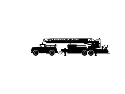 Silhouette of a large truck with a crane on the back
