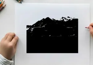 Silhouette of a pickup truck in front of a mountain range
