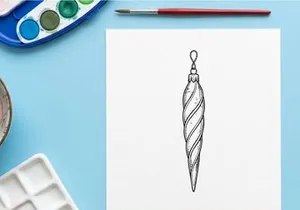 Silver and blue striped Christmas teardrop ornament hanging on white background
