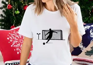 Soccer player kicking ball into goal with silhouette