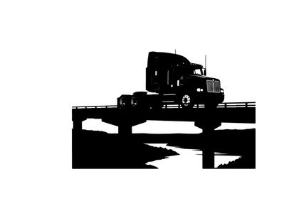 Silhouette of a semi truck driving across a bridge