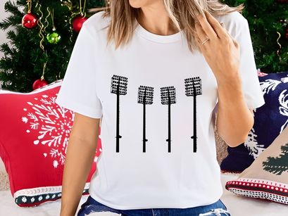 Four identical stadium lights on poles against a white background