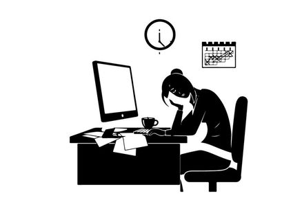 Silhouette of a woman working late at her desk
